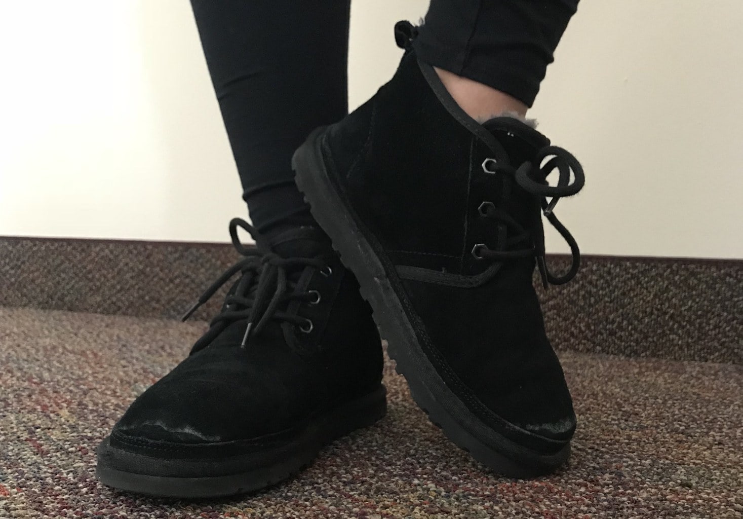 Arianna wears black velvety lace up sneakers with chunky rubber soles.