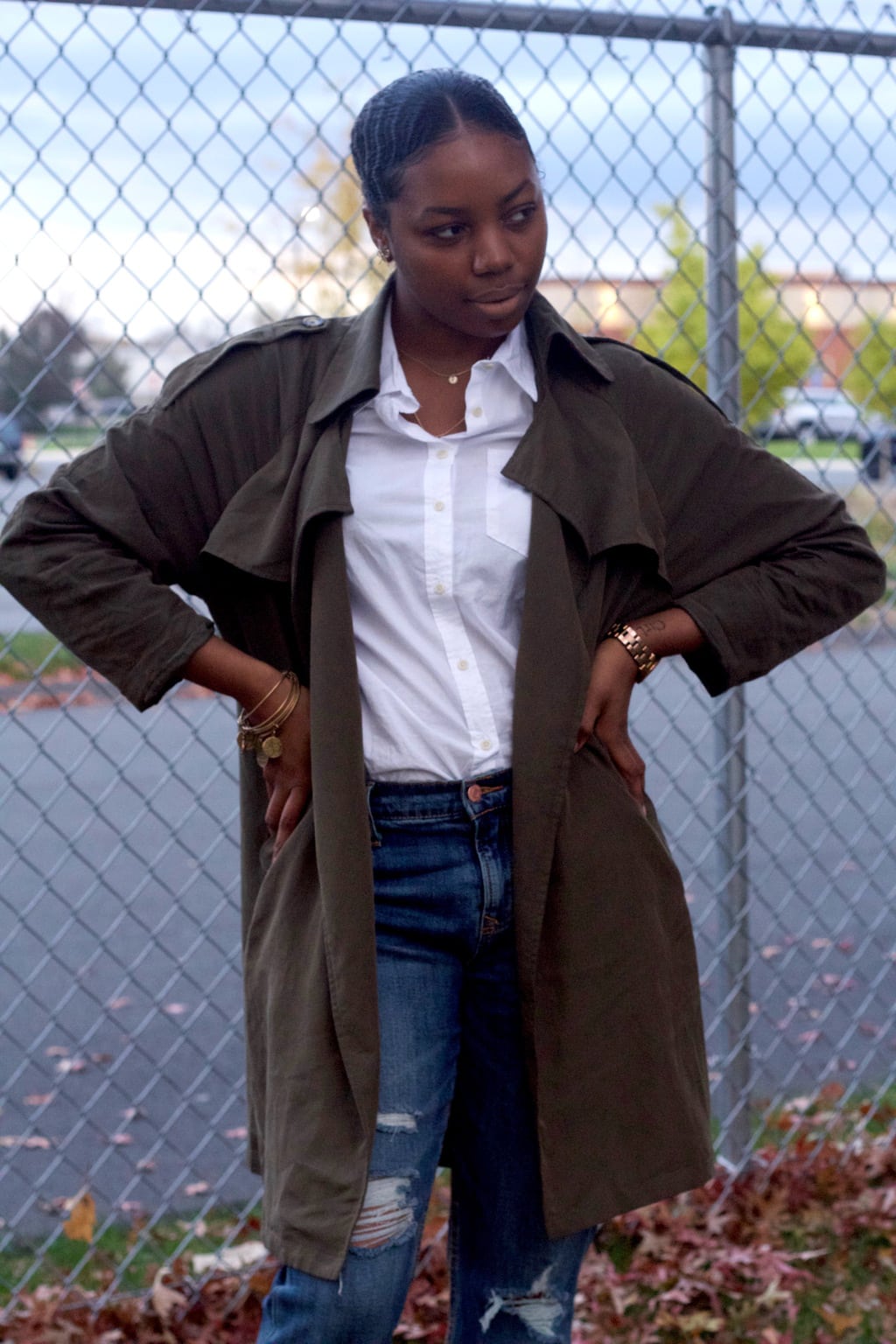 This olive green trench coat outfit is so classy! A green trench is worn with a button-up white blouse tucked in for a classic look.