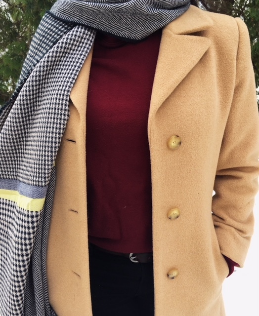 Shannon's tan peacoat pops against her burgundy turtleneck and black and white herringbone and checkered blanket scarf.