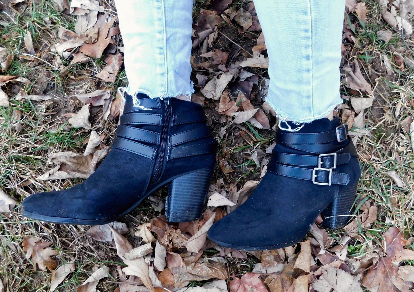 This student wears black chunky-heeled booties with straps and silver buckles.