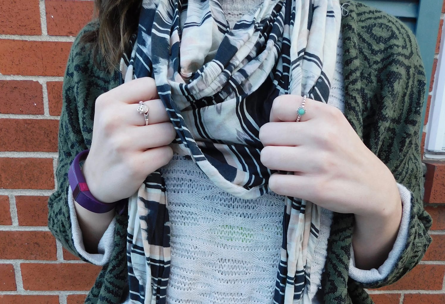 Lauren wears tiny, delicate silver rings, one with a turquoise stone, to compliment her casual look.