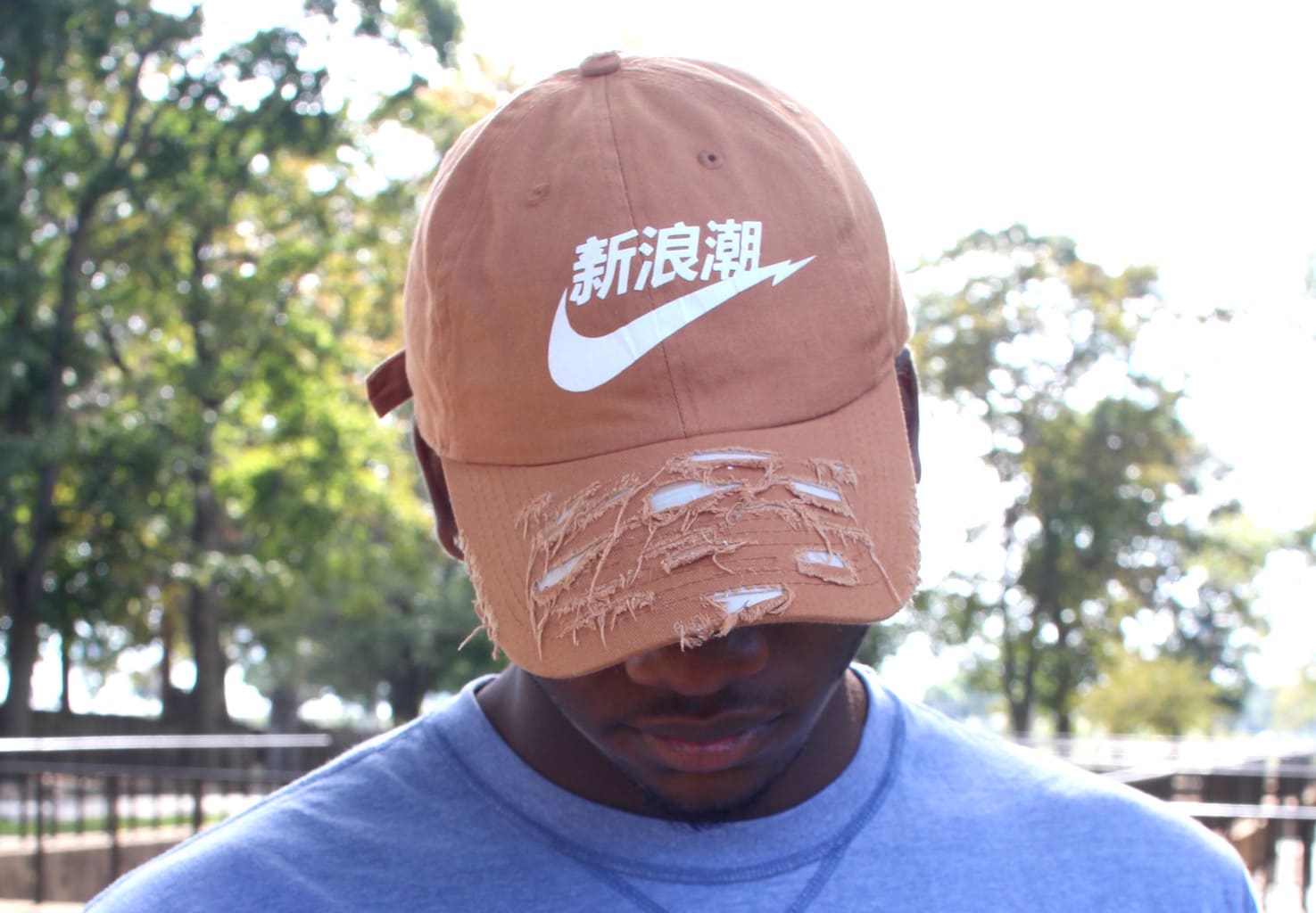 Custom screenprinted and shredded orange baseball cap.