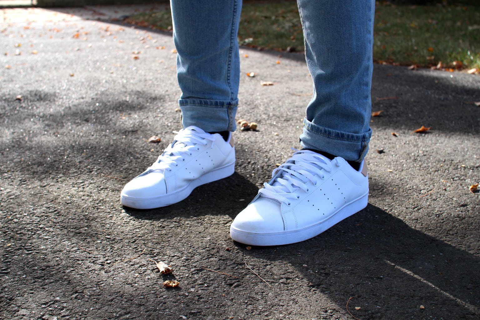 Brandon's ultra-bright Adidas sneakers are worn with cuffed denim jeans.