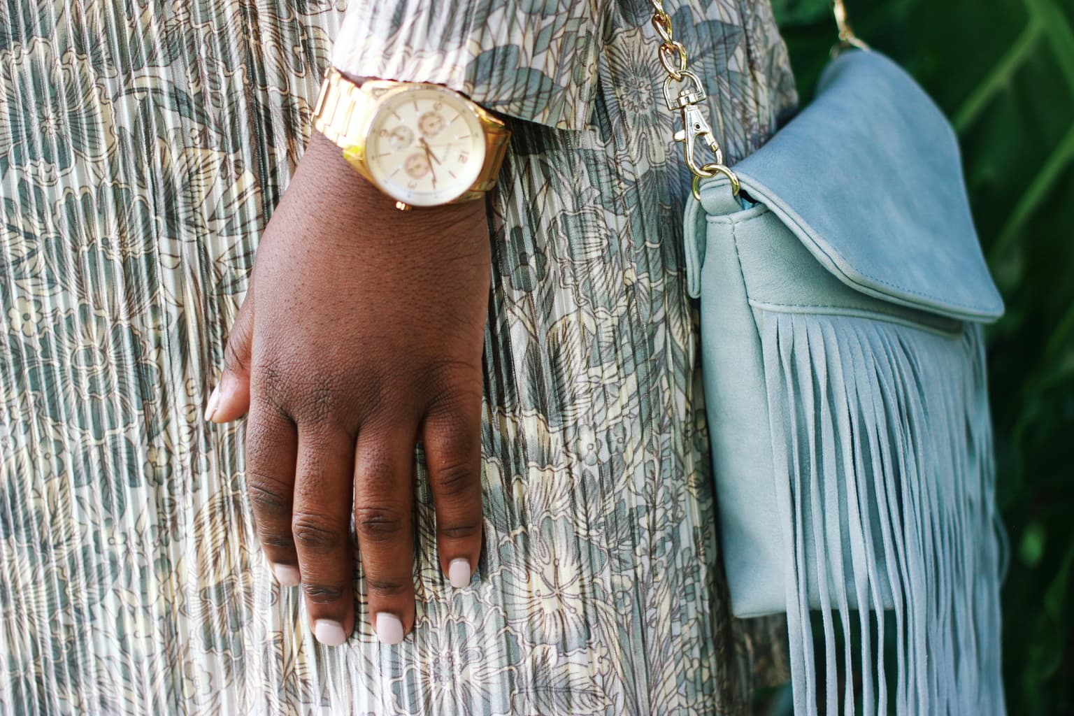 Large-faced gold watch and mint fringe mini purse with a gold chain accent this University of Central Florida student's pleated cream, blue, and gold dress, creating the perfect church outfit for Sunday.