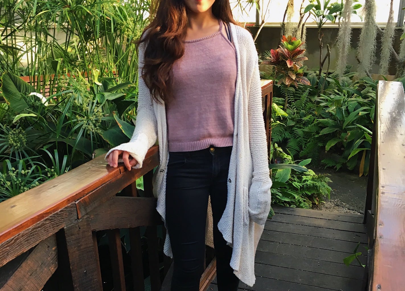 UMass Amherst student Aren wears a simple mauve high-neck knit cami top with a long oatmeal cardigan and dark wash jeans.