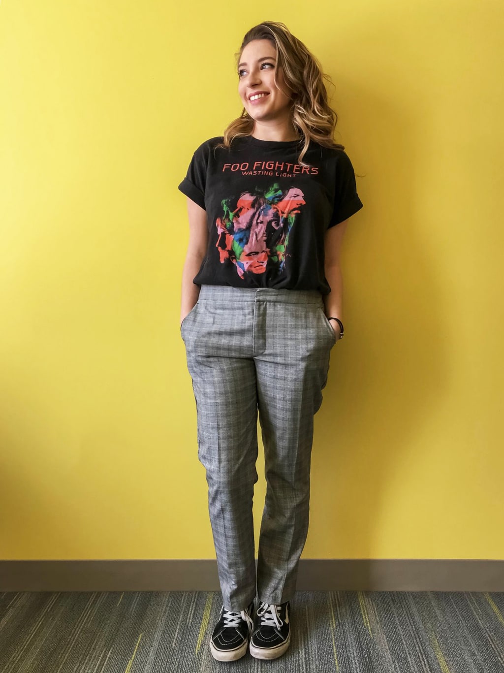 UMass Amherst student style: Caroline wears a vintage short sleeved Foo Fighters tee with a pair of plaid grey trousers and black and white Vans.