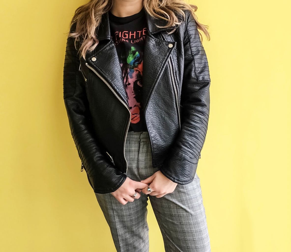 This black leather motorcycle jacket is paired with her Foo Fighters band tee and checkered trousers.