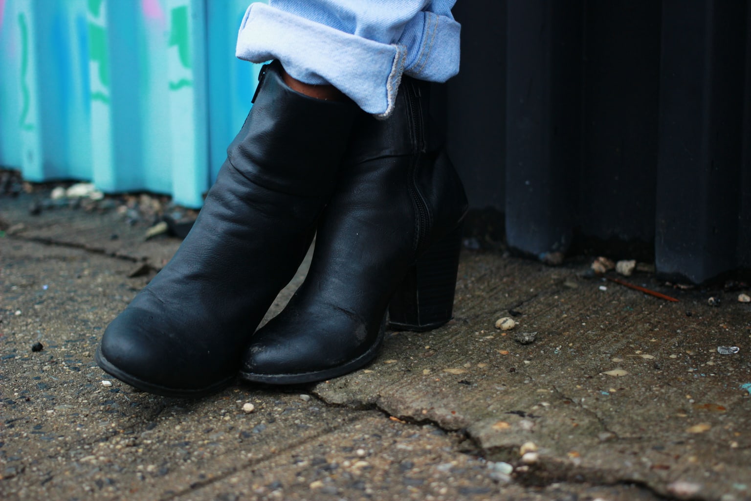 Student wears black chunky-heeled booties around campus for comfort and style.