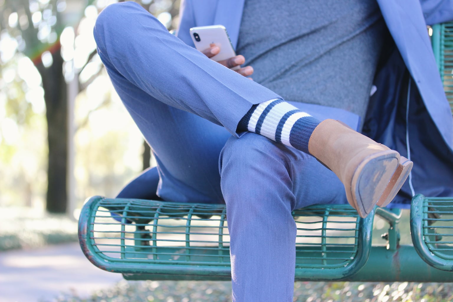 Blue and white striped Perry Ellis socks and tan ankle boots polish off this blue suit.