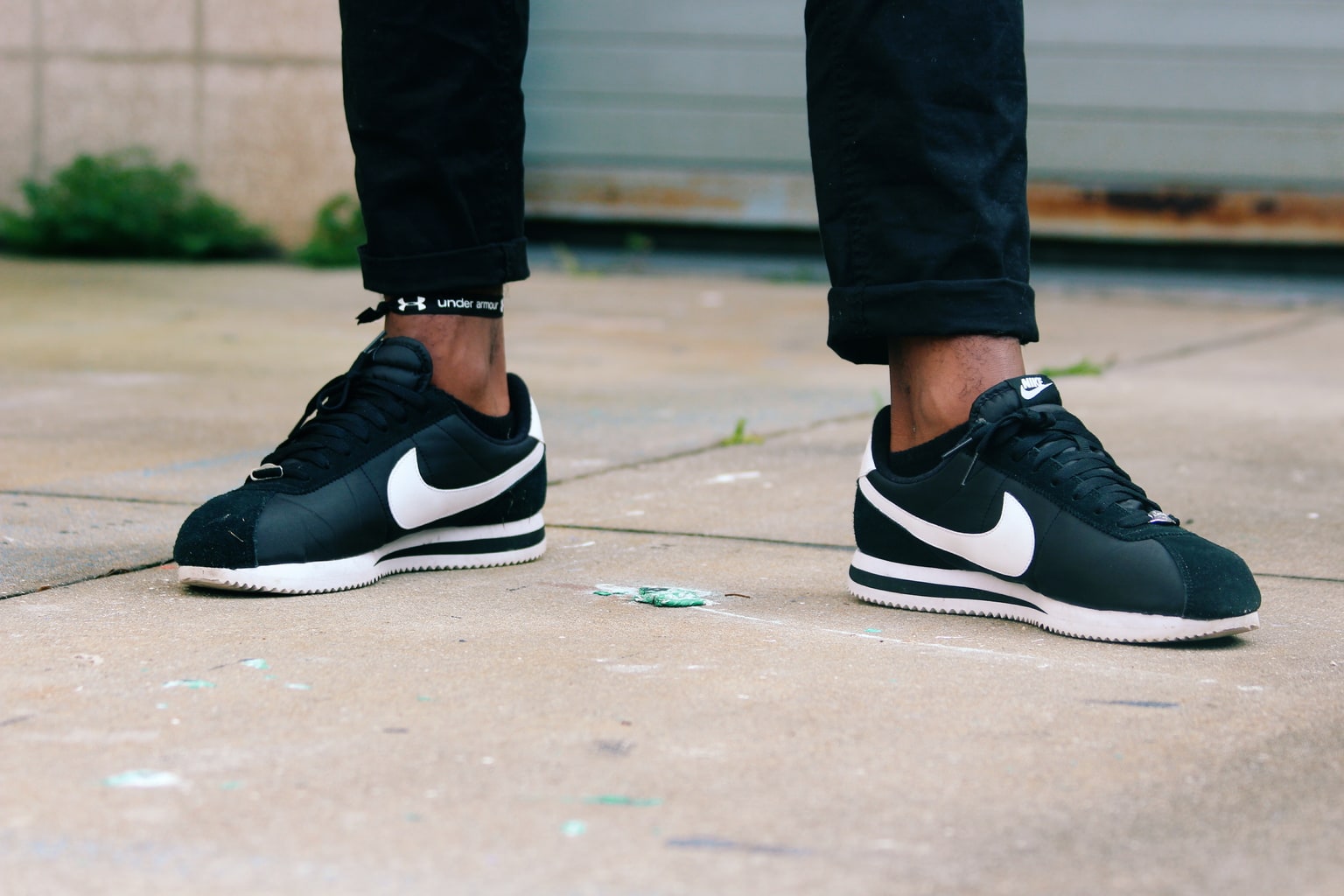 University of South Florida student wears a pair of black and white Nike Cortez lace up sneakers.