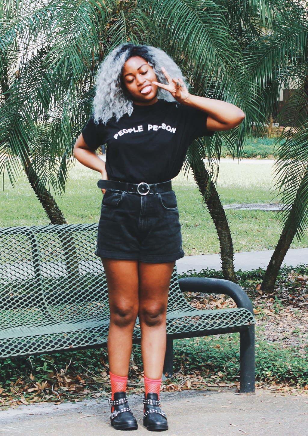 University of South Florida student Lundyn wears an all-black summer grunge look. Her tucked-in t-shirt reads 