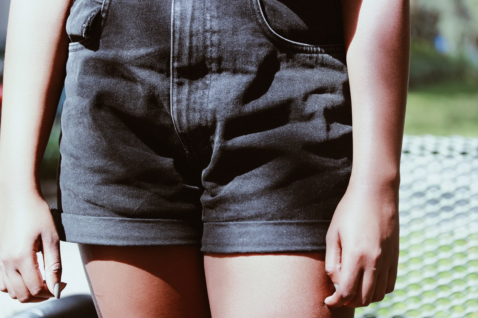 These black denim high-waisted mom shorts are weather-appropriate during the warm fall months.