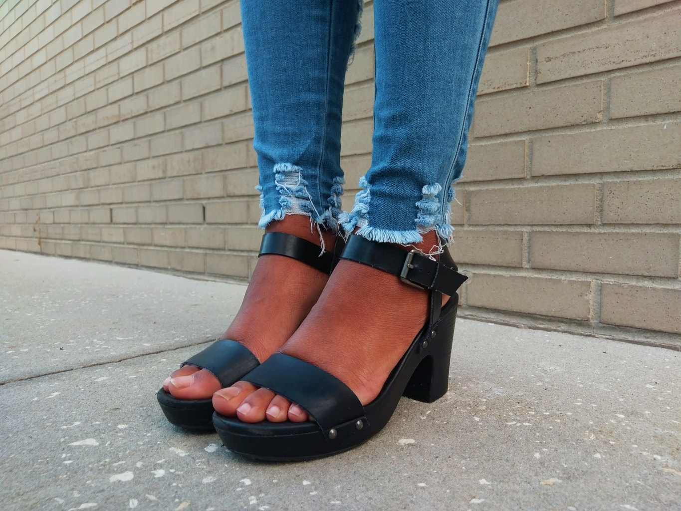 Payton's simple and chunky-heeled sandals have a one-inch platform and buckle straps around the ankle.