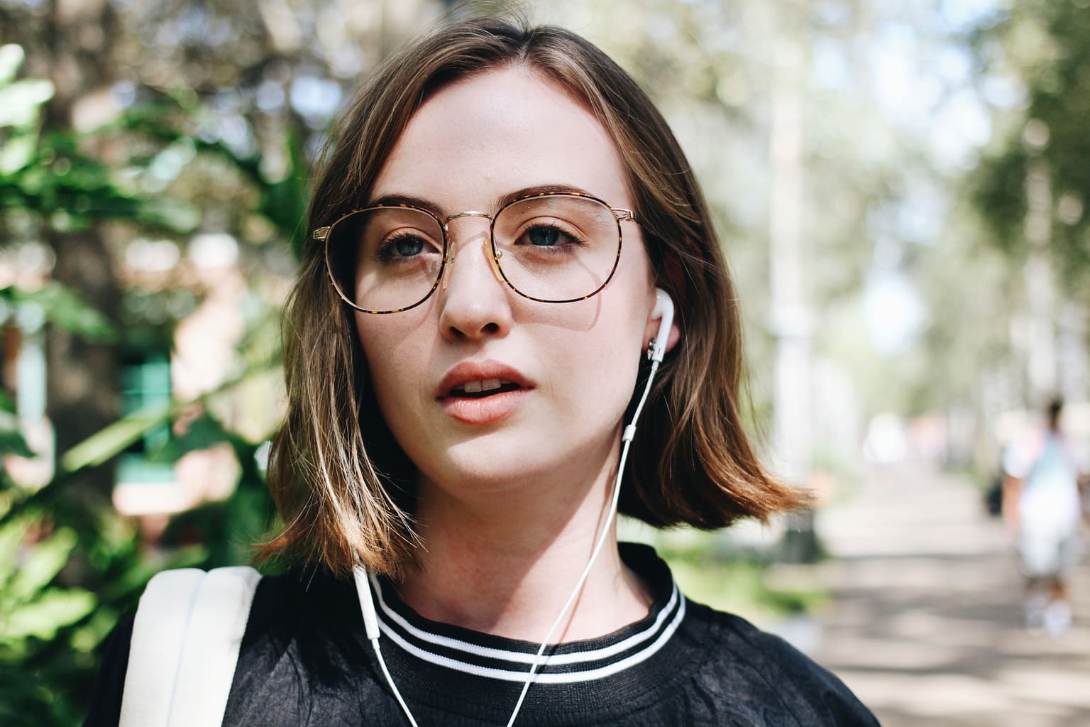 Taylor, a student at the University of South Florida wears thin-framed oval glasses as an accessory.