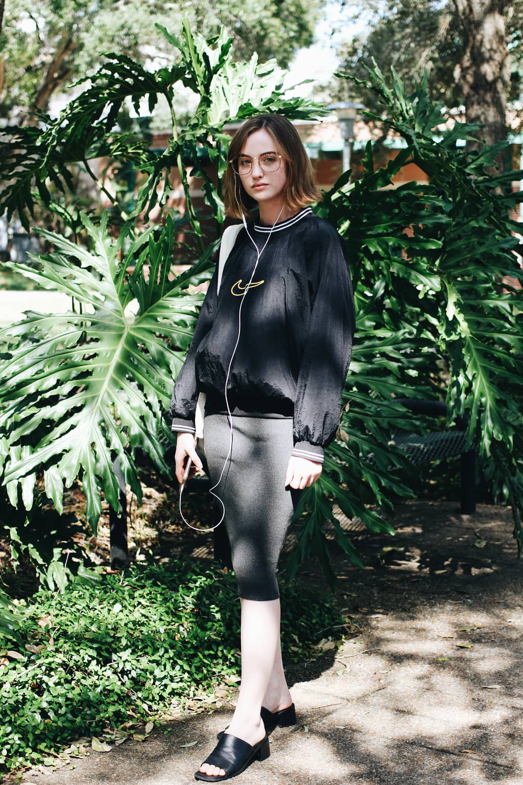 University of South Florida student Taylor wears a vintage oversized Nike athleisure pullover with a knit grey knee-length pencil skirt and chunky-heeled slip ons.