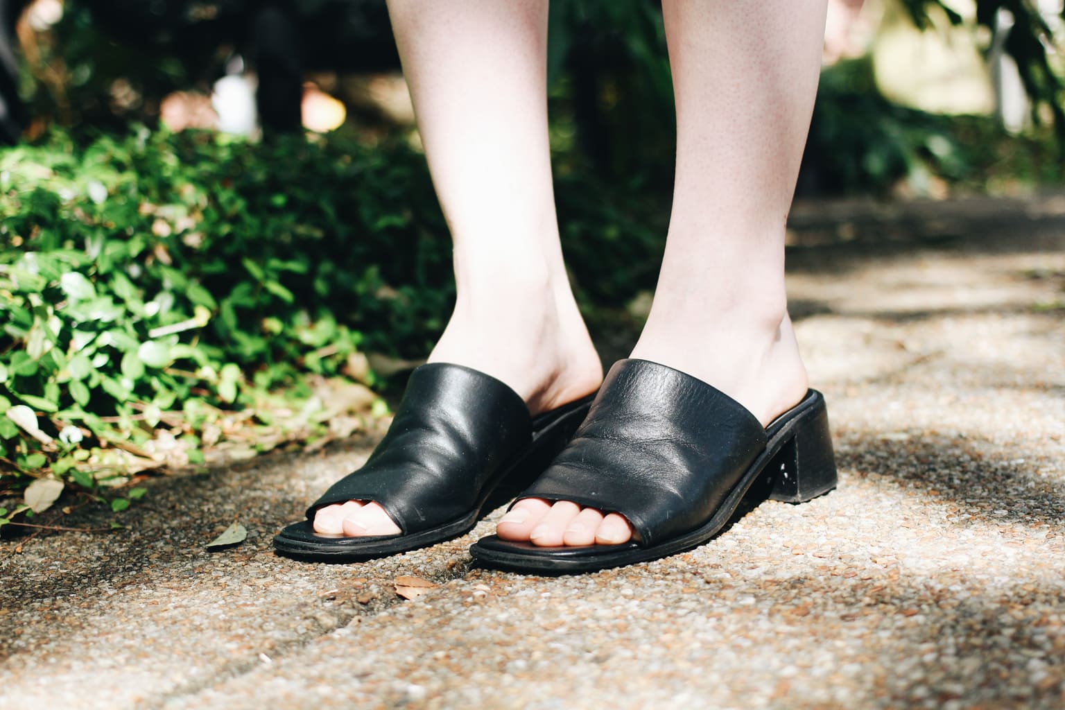 Chunky-heeled black slide-on vintage sandals.