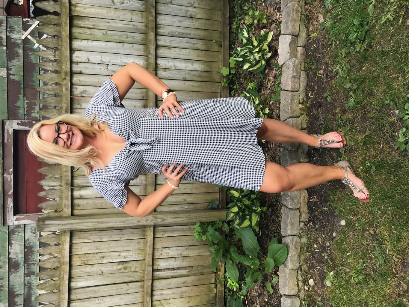 Madeline, a student at the University of Utah, wears an empire-waist summer gingham dress with short ruffled sleeves and a bow in the front, paired with silver bejeweled sandals.