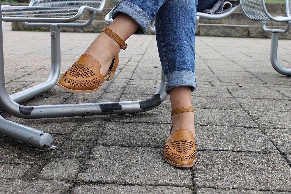 Alyssa's shoes are flat medium brown loafer-style sandals with ankle straps.