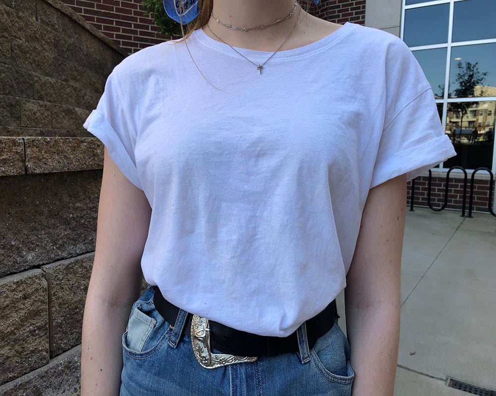 This West Virginia student wears a loose-fitted plain white tee tucked into her high-waisted denim skirt.