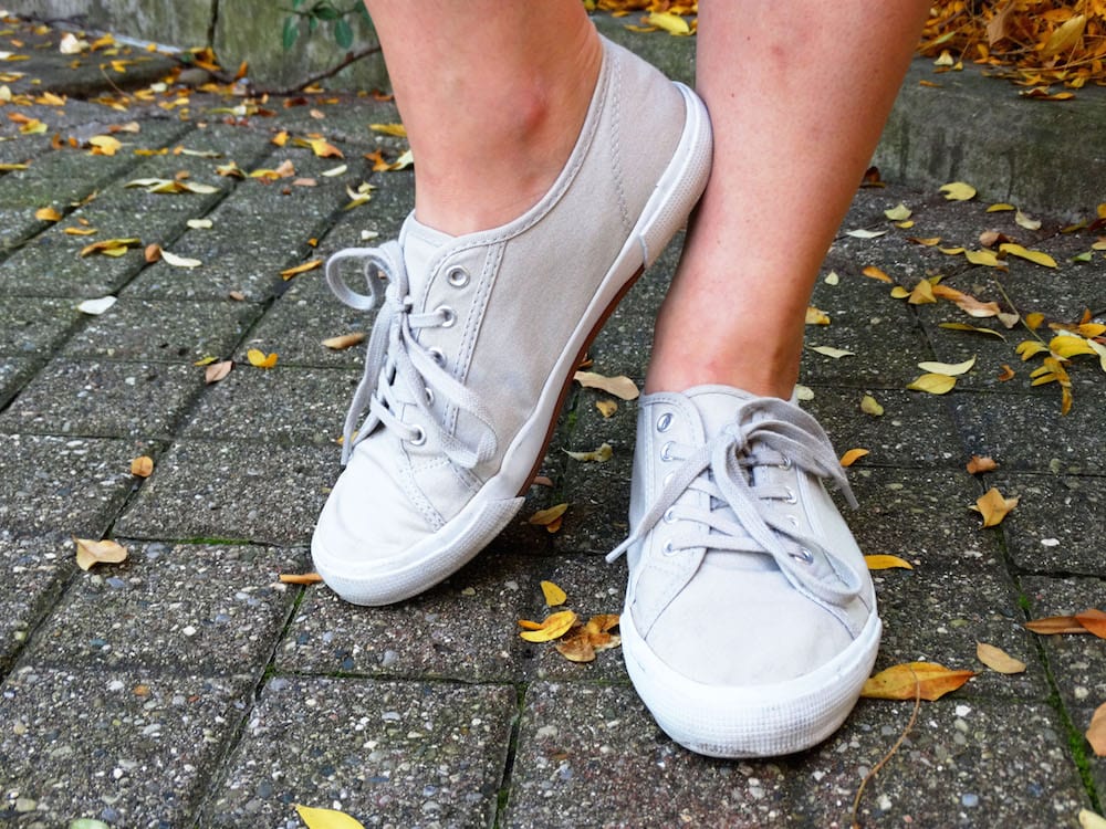 Light grey canvas lace-up sneakers, perfect for West Virginia University student Emma to wear on campus.