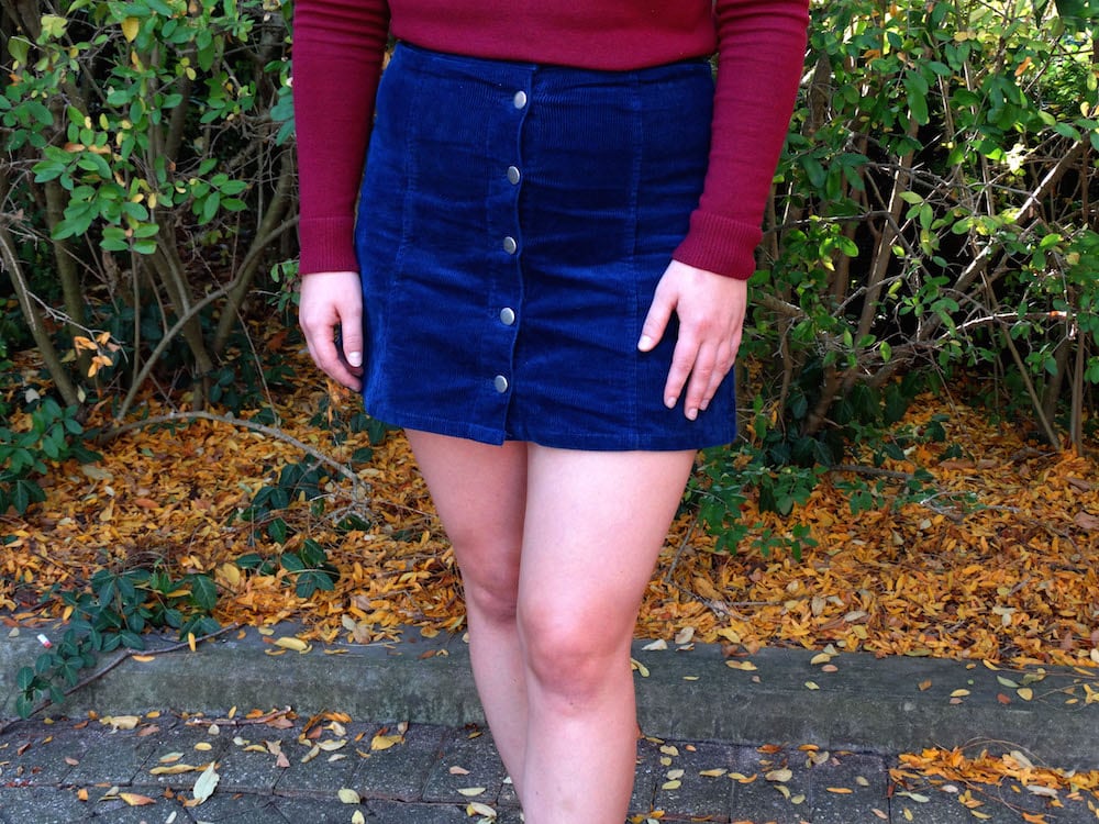 This blue high-waisted corduroy skirt buttons up the front.