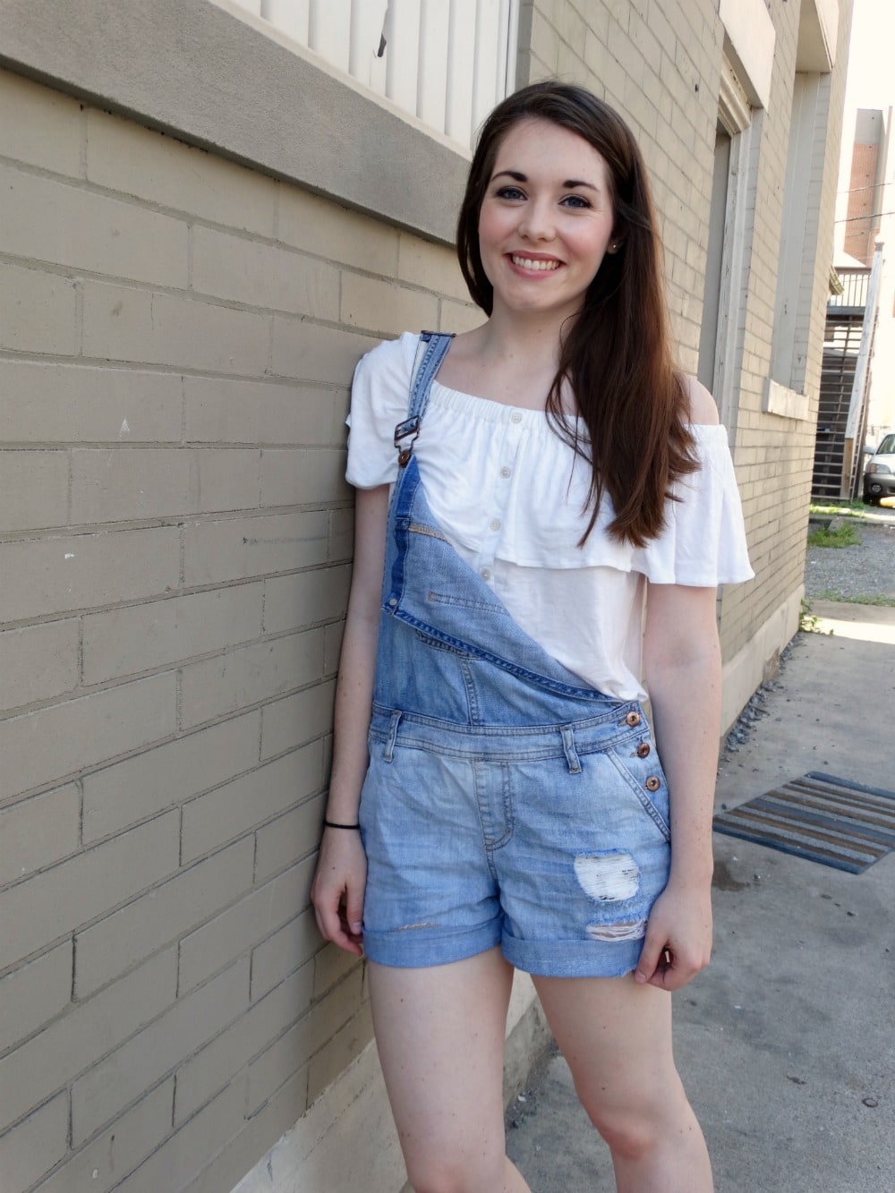 Street style: student at West Virginia University wears a white off-the-shoulder top with overall shorts