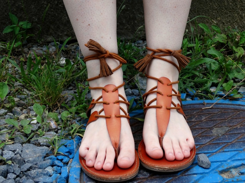 Brown strappy gladiator sandals on a student at West Virginia University.