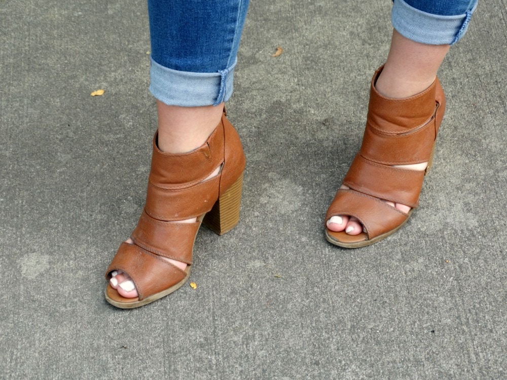 Chunky medium brown strappy block heels worn with cuffed skinny jeans.