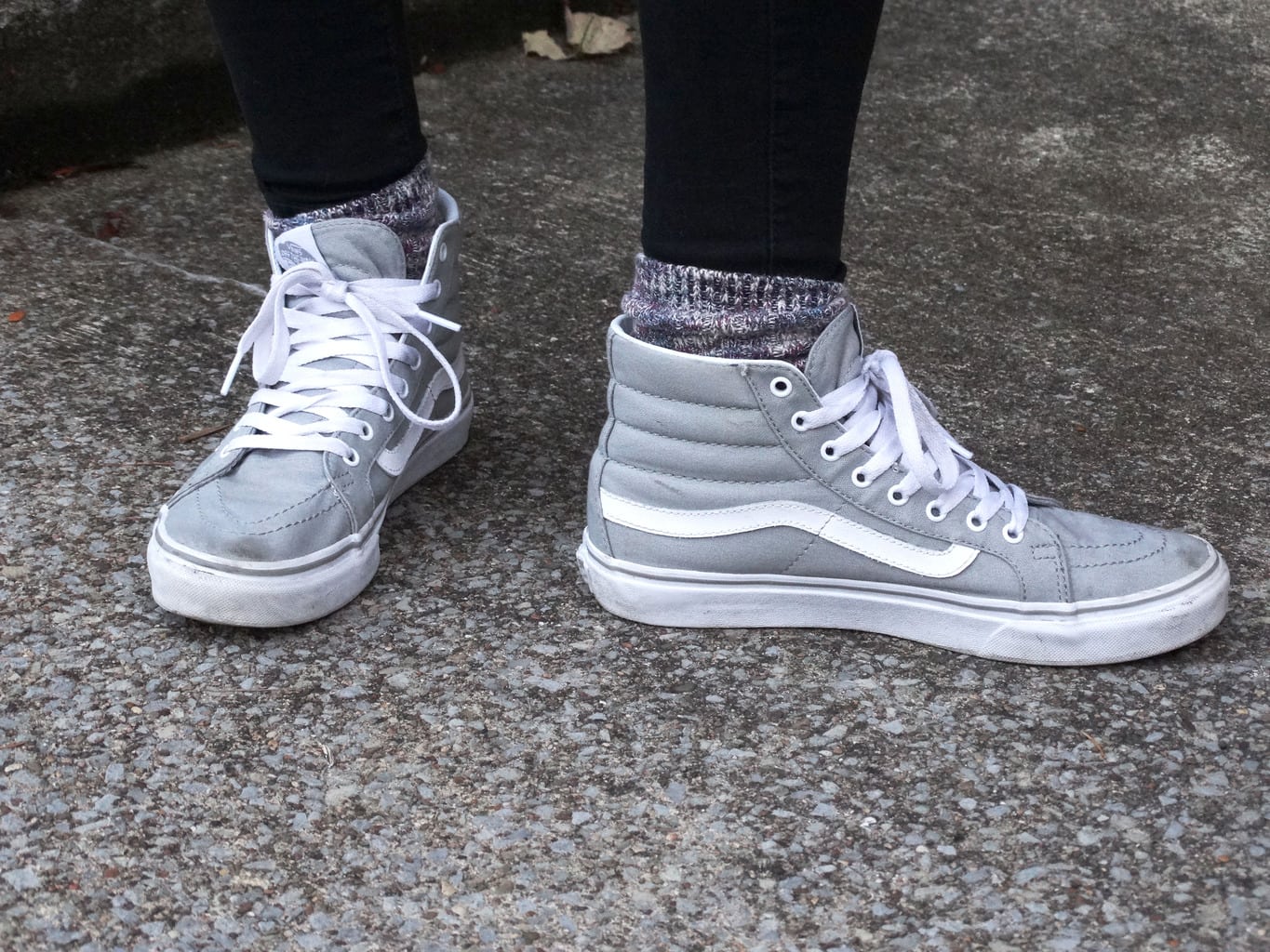 Sporty grey footwear for this West Virginia University student. She pairs these light grey hightops with chunky marbled socks peeking out of the top.