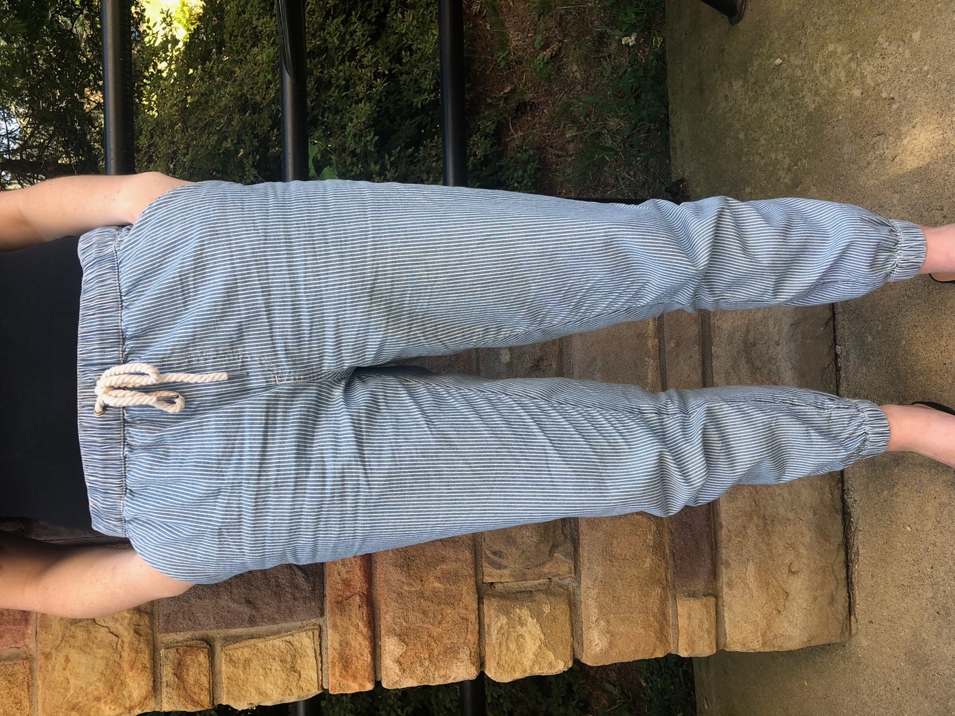 Maggie wears blue and white striped nautical joggers with a rope drawstring.