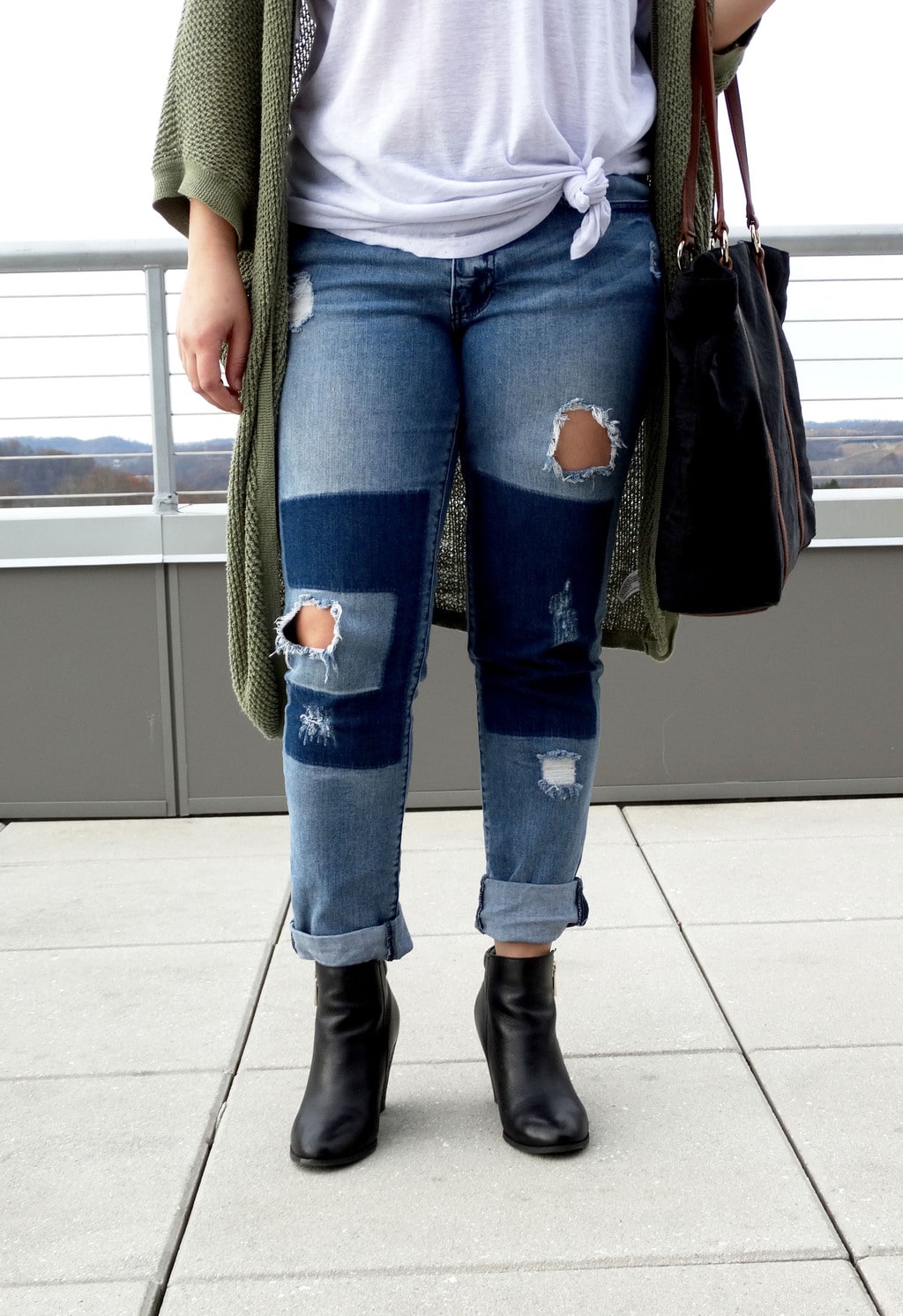 West Virginia University student Mel wears distressed patchwork boyfriend jeans cuffed to show off her chunky black booties.