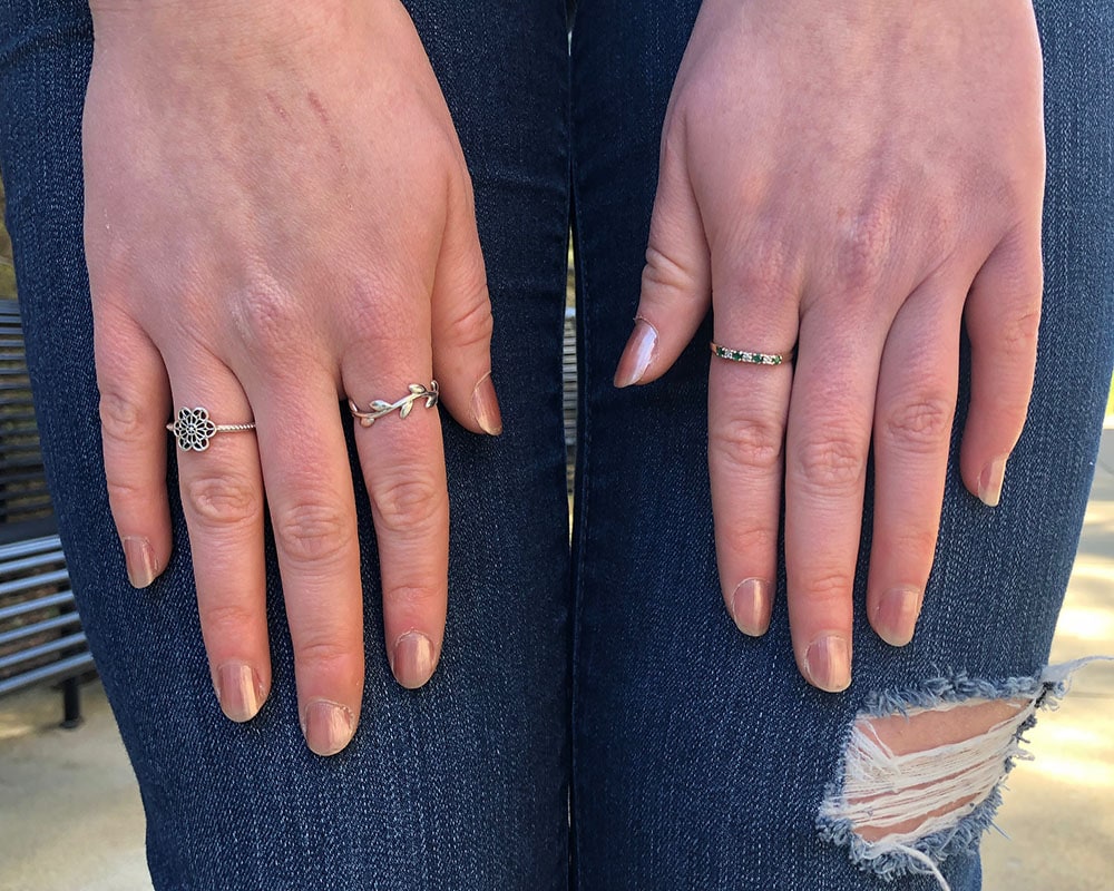 This West Virginia University student wears mixed metal jewelry; a simple silver botanical band, a mandala, and a simple gold hand-me-down with tiny emeralds.