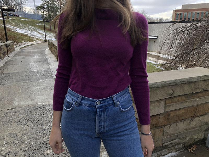 This bright eggplant sweater was a thrift store find that Morgan styles with high-waisted light-wash denim jeans.