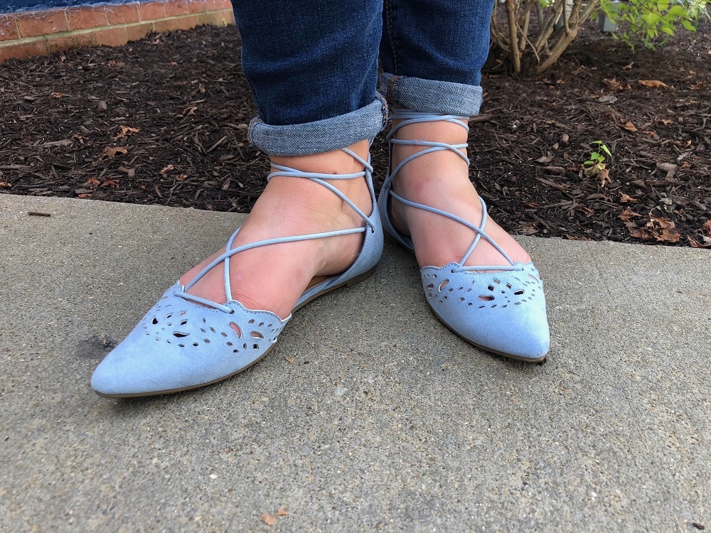 Sarah wears pointed-toe baby blue flats with ankle ties.