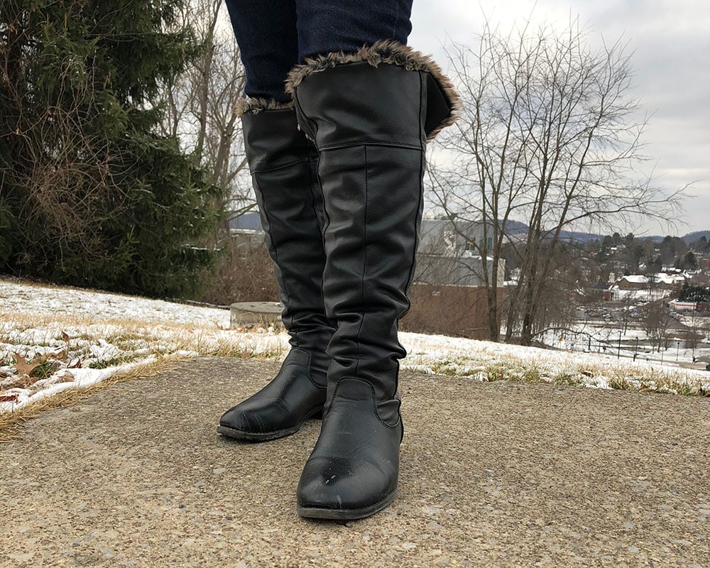 These flat black knee-high boots are lined with fur for cold and snowy days on campus.