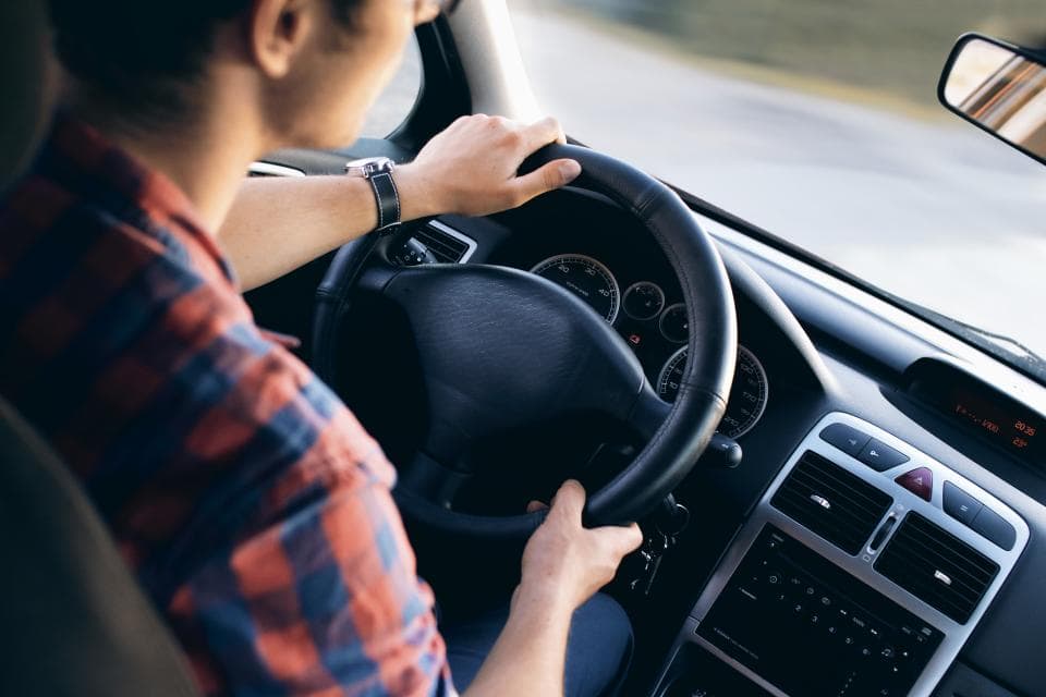 Man wearing plaid in car driving