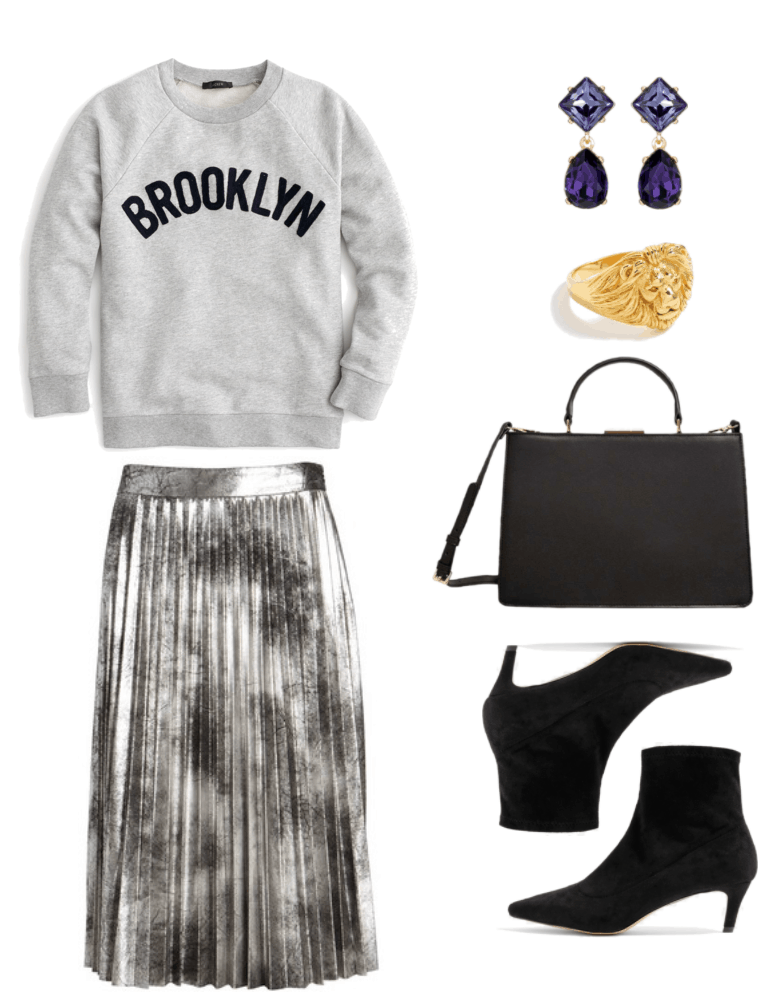 Light heather-gray crewneck sweatshirt with black "BROOKLYN" graphic, silver and black metallic pleated midi skirt, gold drop earrings with lavender diamond-shaped stone and dark purple teardrop-shaped stone, gold lion's head ring, black top-handle cross-body bag with clasp and gold hardware, black kitten heel sock ankle boots with pointed toe