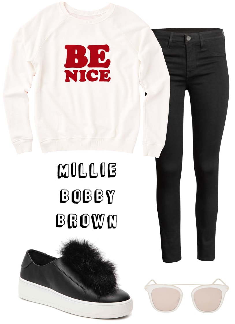 Millie Bobby Brown Outfit: Be Nice graphic sweatshirt, cropped black skinny jeans, platform slip on sneakers with fur accent, brow bar sunglasses