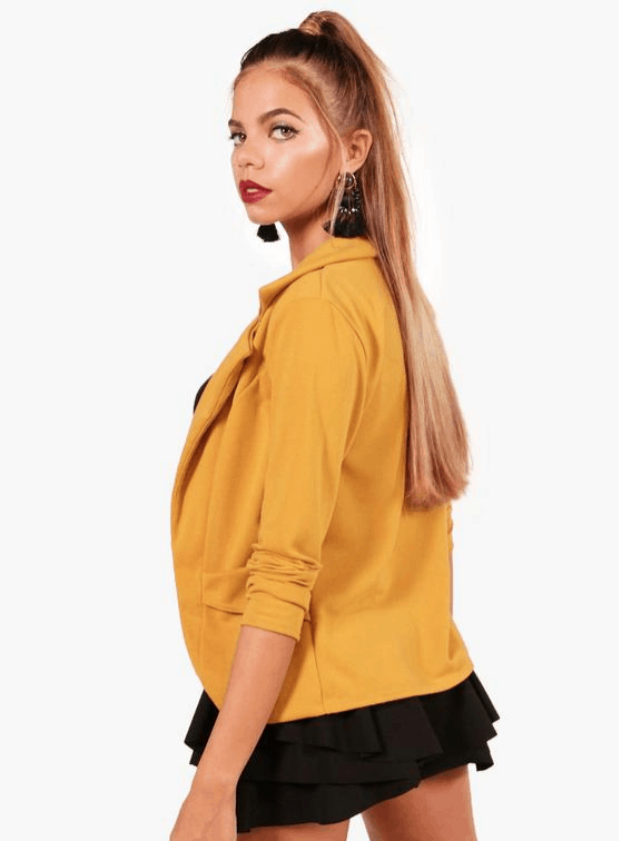 Boohoo model wearing a mustard blazer.