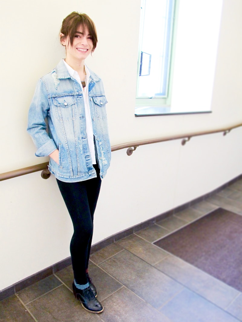Campus fashion at MSU - student Grace wears a distressed jean jacket, white button-down shirt, leggings, and oxfords