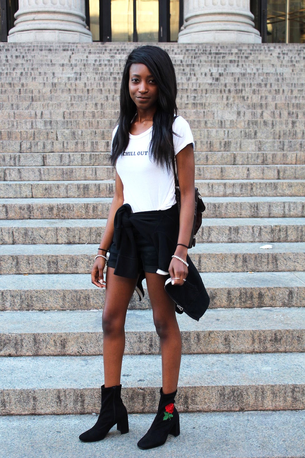 Outfits for College: Street style example. College student from University of Missouri wears a Chill Out graphic tee shirt, rose embroidered booties, black shorts, and a black mini backpack