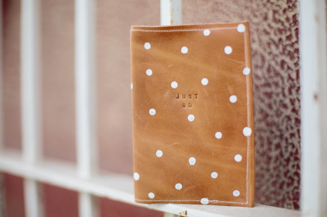 Photo containing leather passport holder with white polka dots.