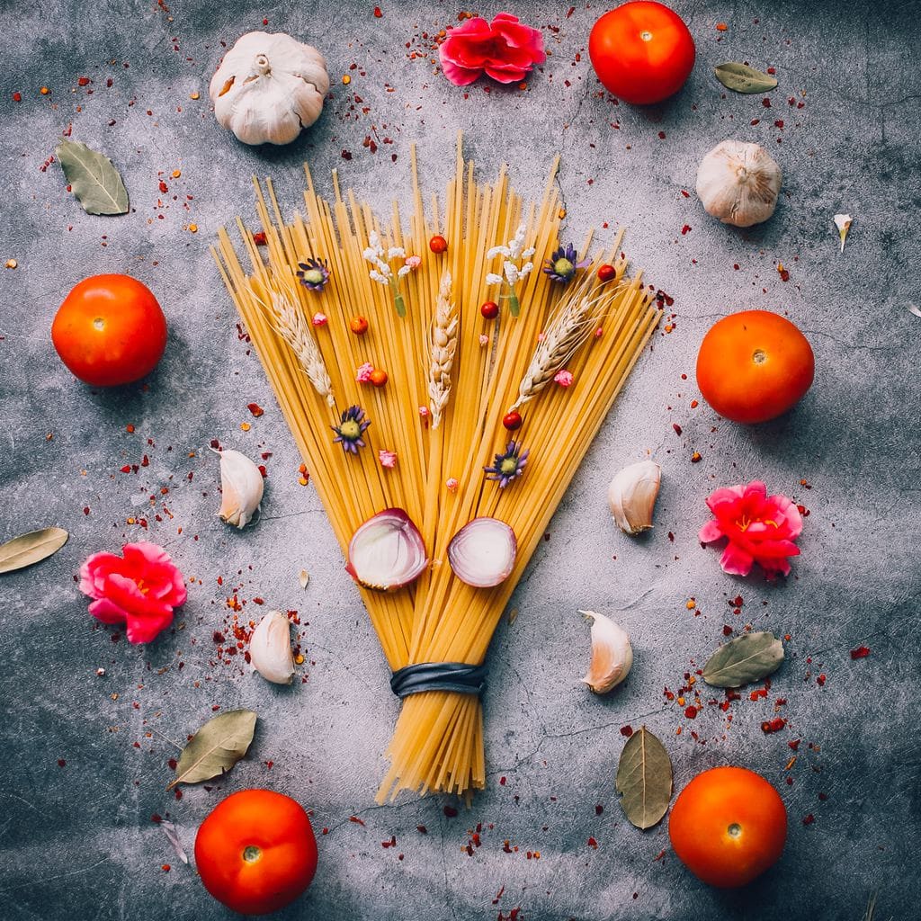 uncooked pasta with garlic and tomatoes