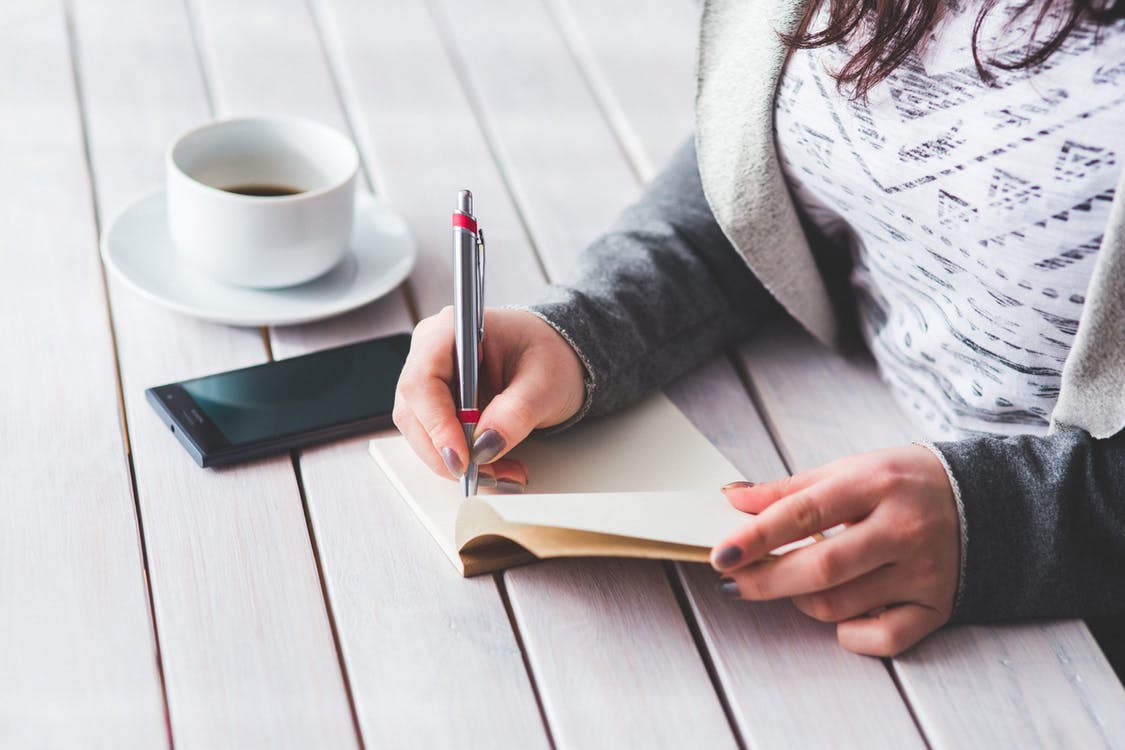 woman writing at desk