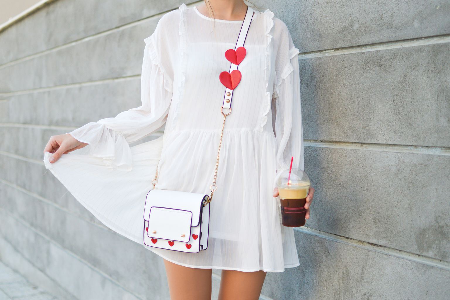 Girl wearing crossbody bag with hearts