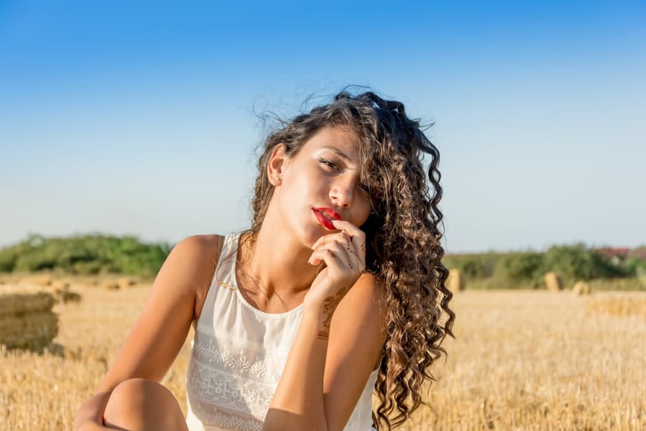 girl with curly hair in field