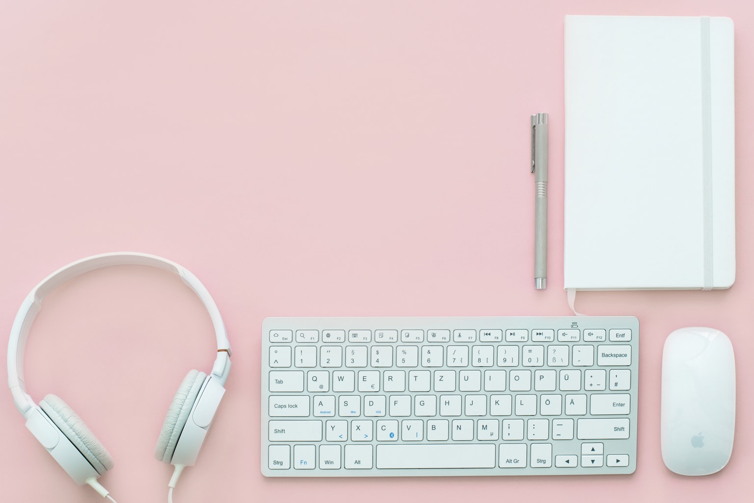 Pink office desk with white accessories