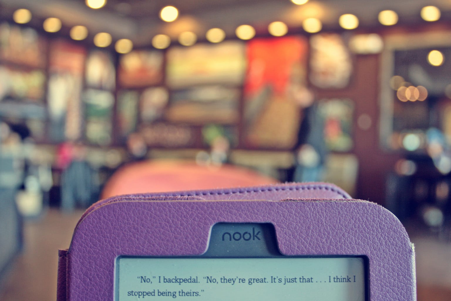 Purple nook tablet reader with a book opened on the screen