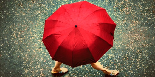 Girl carrying red umbrella