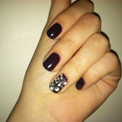 Rhinestones on burgundy nail polish